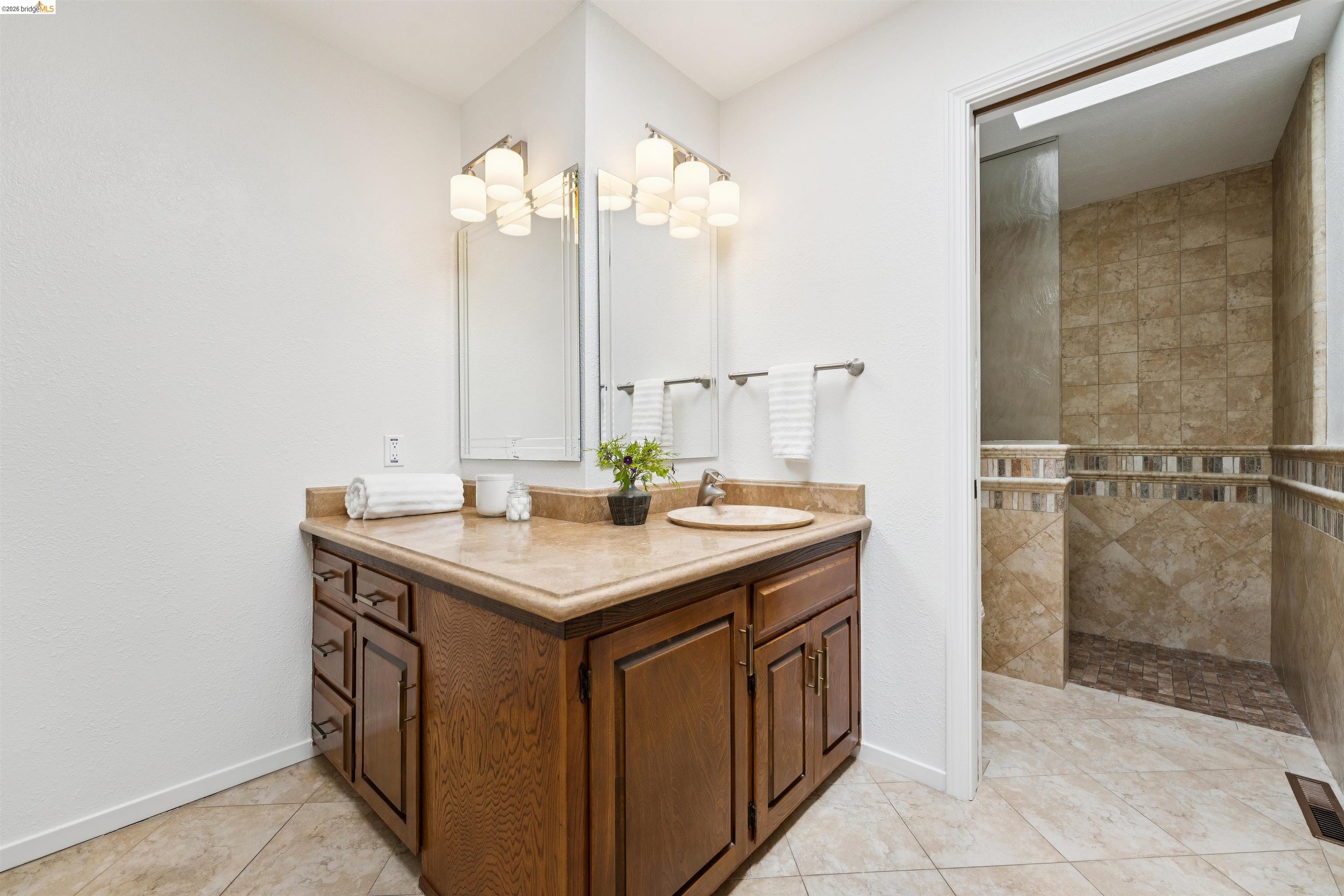 7 Jo Lin Court El Sobrante, CA 94803 - Photo 74 of 99 Bathroom vanity with wood cabinetry, an integrated sink, and a light-colored countertop