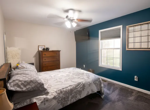 a bedroom with a bed and window