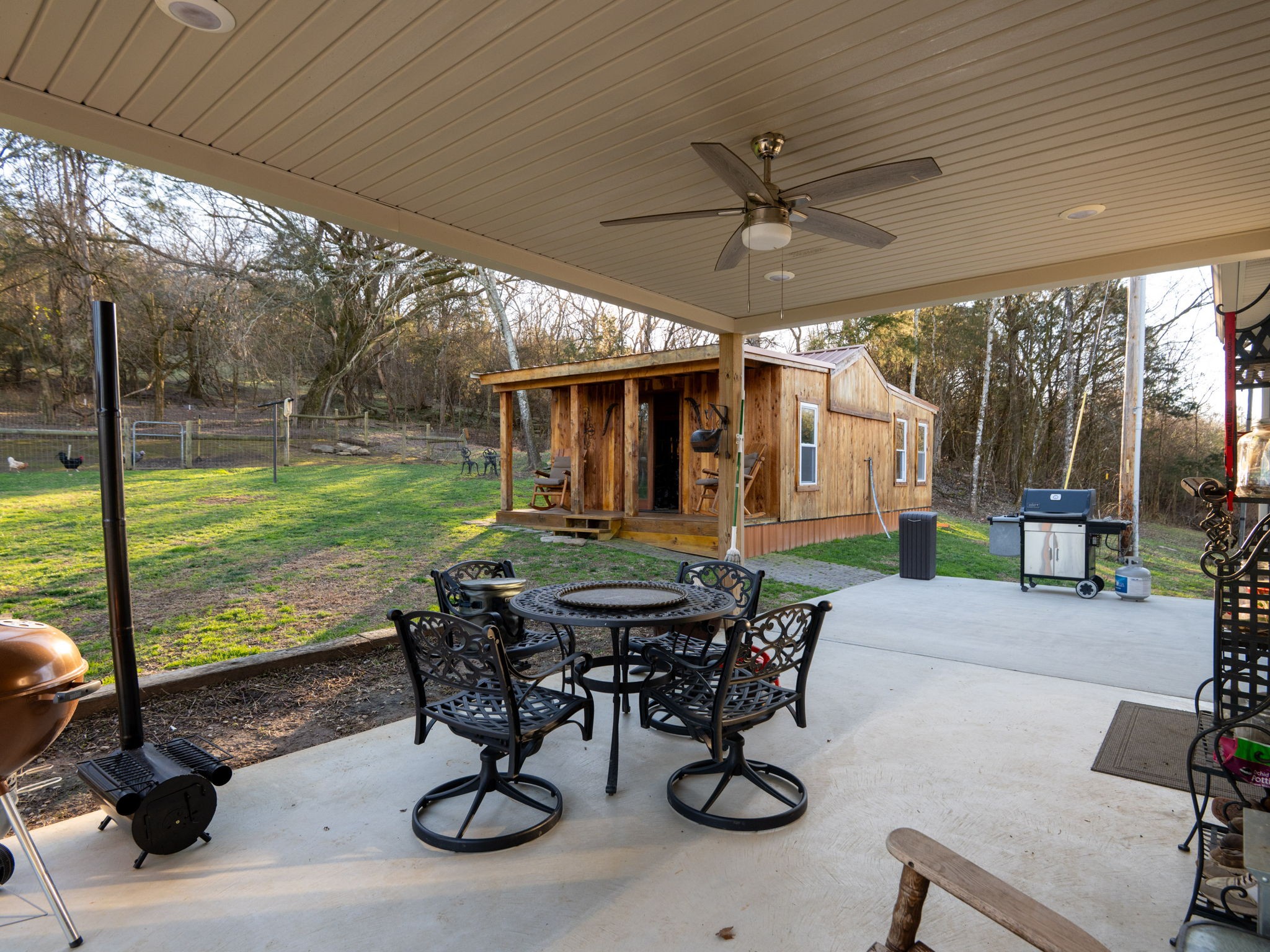 14 Lost Creek Road Carthage, TN 37030 - Photo 27 of 28 a view of a patio with table and chairs potted plants with wooden floor and fence