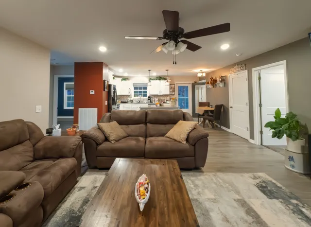 a living room with furniture and a chandelier