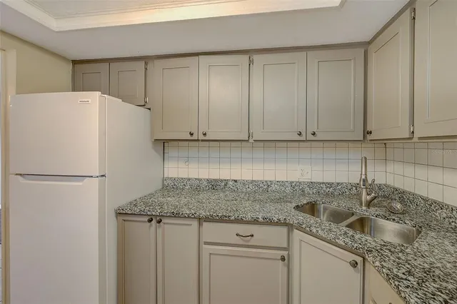 a white refrigerator freezer sitting inside of a kitchen