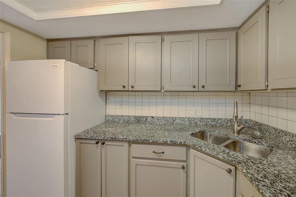 1329 Drew Street, Unit 4 Clearwater, FL 33755 - Photo 14 of 34 a white refrigerator freezer sitting inside of a kitchen