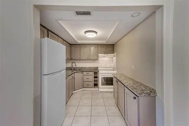 a kitchen with a refrigerator sink and stove