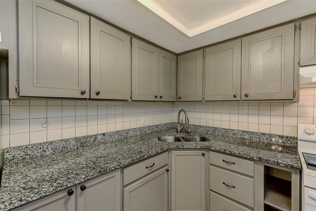 1329 Drew Street, Unit 4 Clearwater, FL 33755 - Photo 17 of 34 a kitchen with appliances cabinets and a counter top space