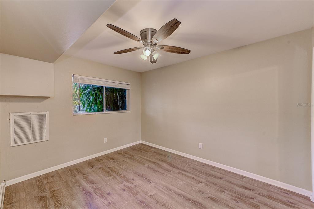 1329 Drew Street, Unit 4 Clearwater, FL 33755 - Photo 6 of 34 a view of an empty room with window and wooden floor