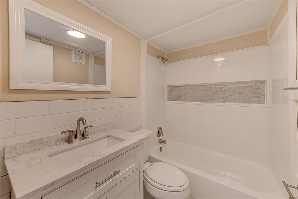 1329 Drew Street, Unit 4 Clearwater, FL 33755 - Photo 8 of 34 a bathroom with a sink a toilet and shower