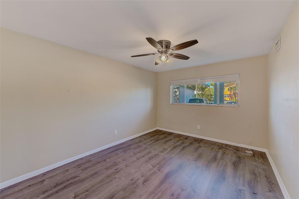 1329 Drew Street, Unit 4 Clearwater, FL 33755 - Photo 9 of 34 a view of an empty room with wooden floor and a window