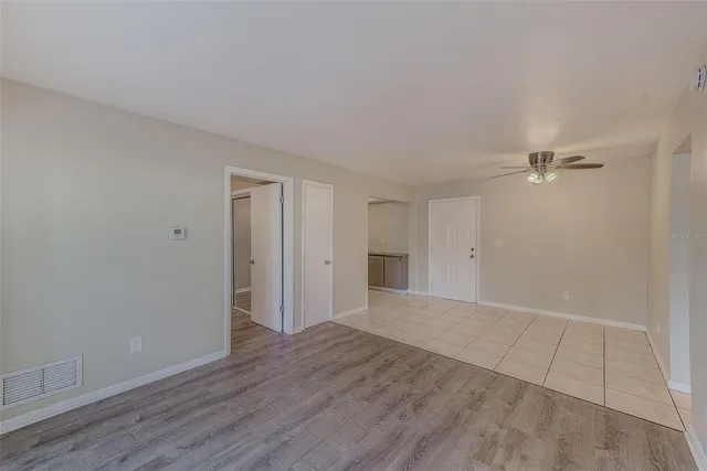 a view of an empty room with wooden floor