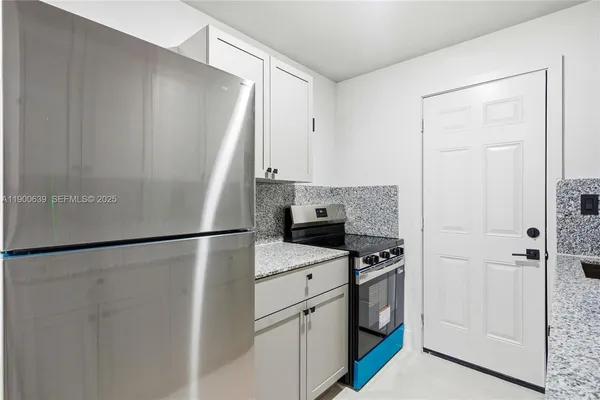 a white refrigerator freezer sitting inside of a kitchen
