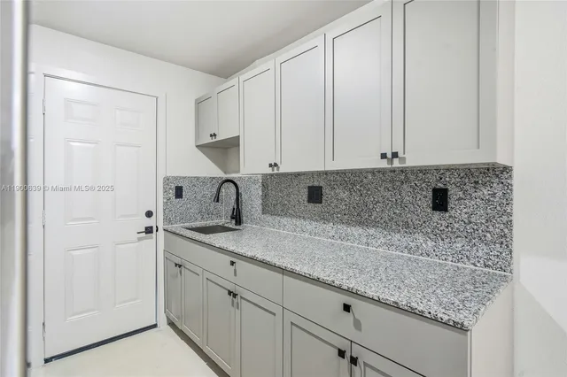 a kitchen with a sink and cabinets