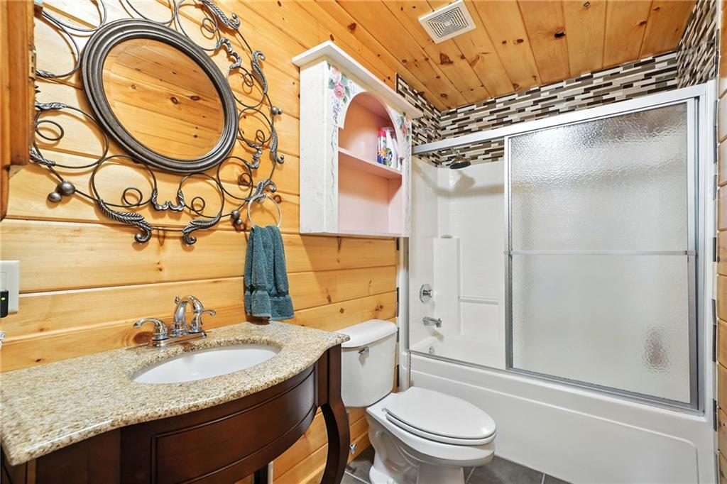 59 Bear Track Trail Morganton, GA 30560 - Photo 23 of 37 a bathroom with a granite countertop sink toilet and shower