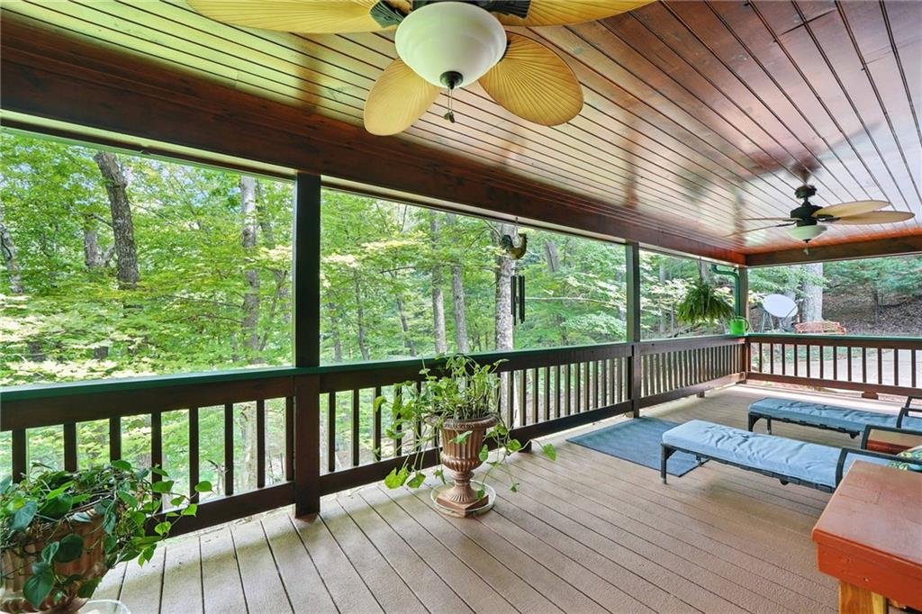 59 Bear Track Trail Morganton, GA 30560 - Photo 27 of 37 a balcony with wooden floor outdoor seating and trees in the back