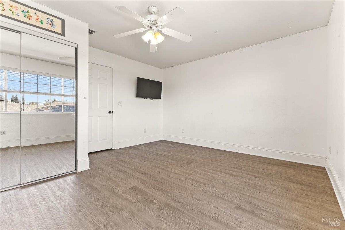 4457 Graywhaler Lane Rohnert Park, CA 94928 - Photo 26 of 51 an empty room with wooden floor and window