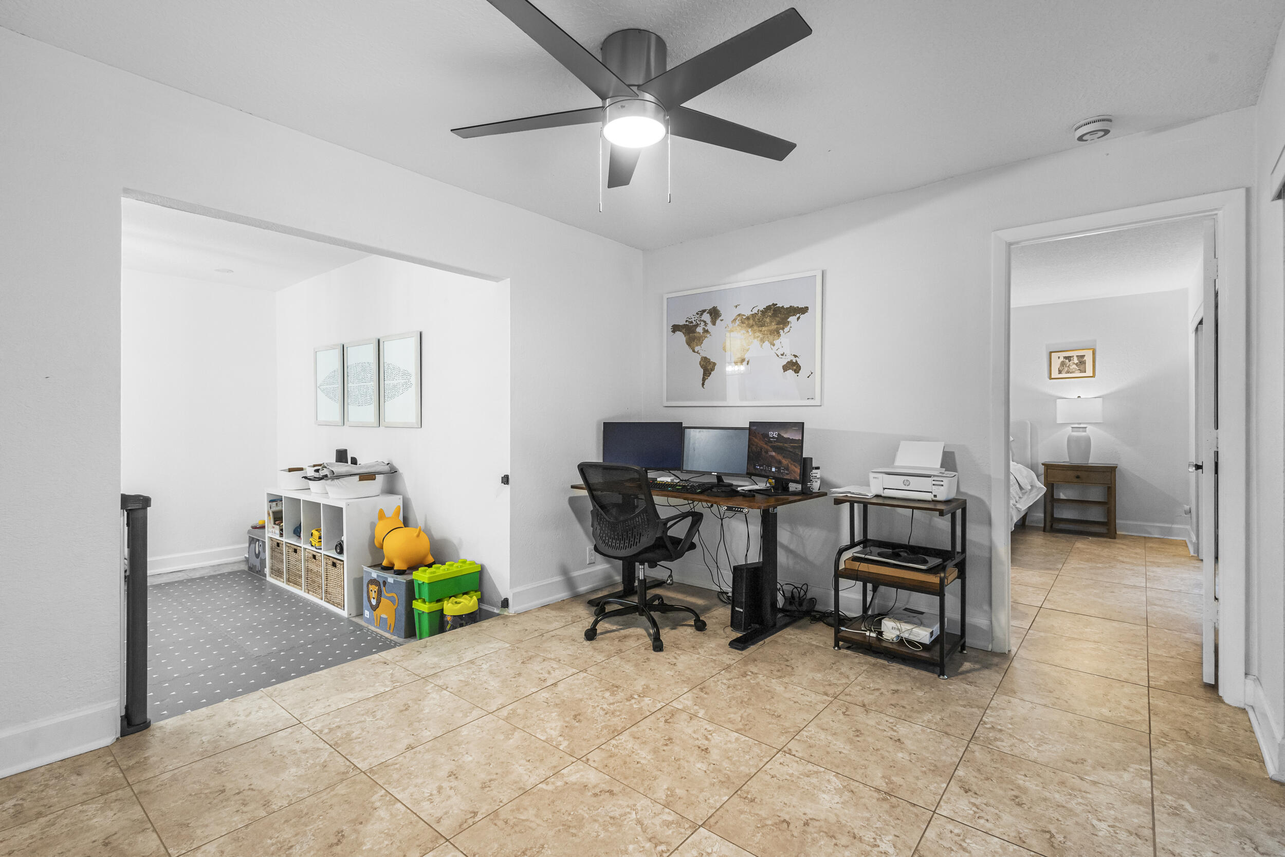 1948 Southwest 36th Avenue Delray Beach, FL 33445 - Photo 19 of 40 a work room with furniture and a chandelier fan