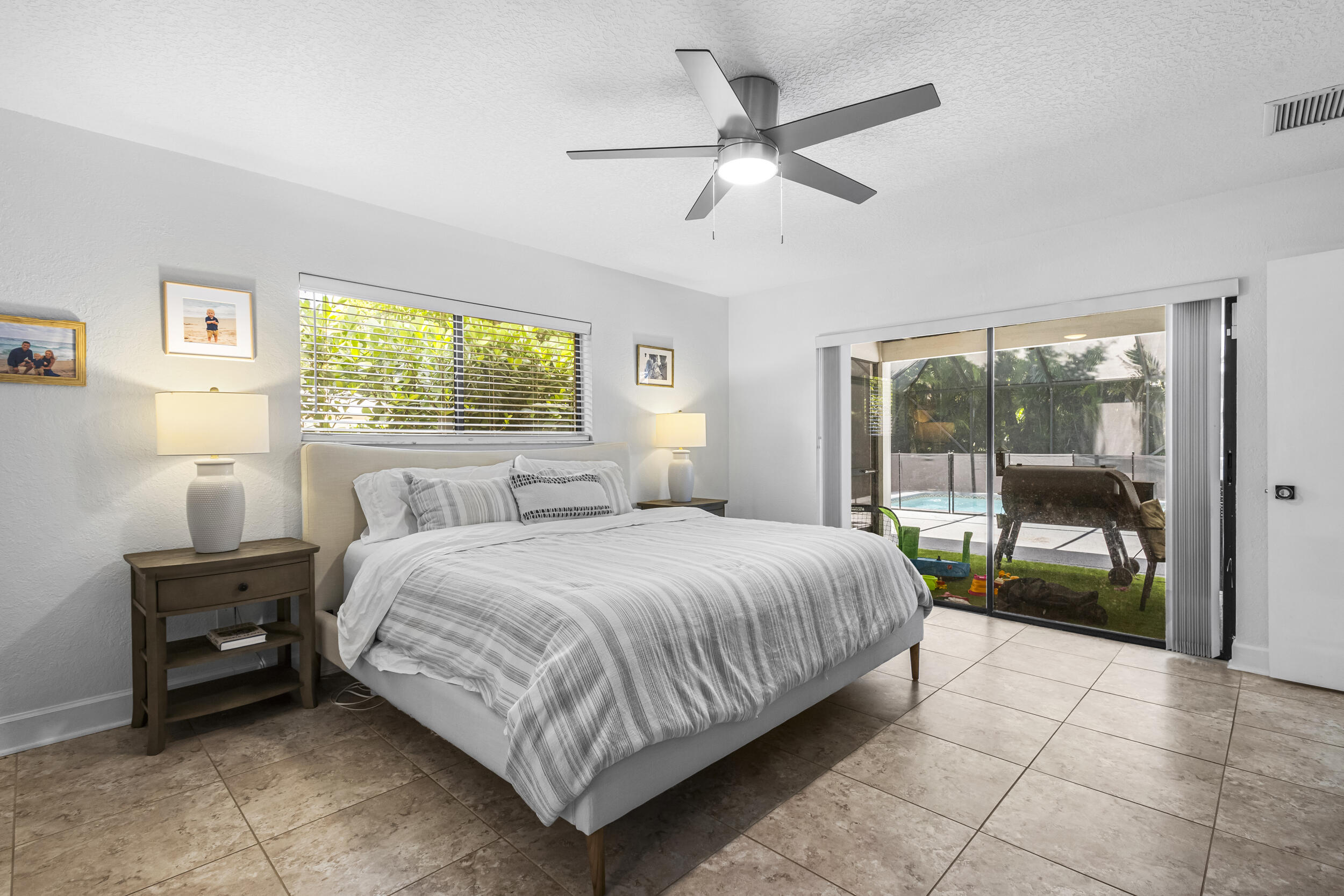 1948 Southwest 36th Avenue Delray Beach, FL 33445 - Photo 21 of 40 a bedroom with a bed and a large window