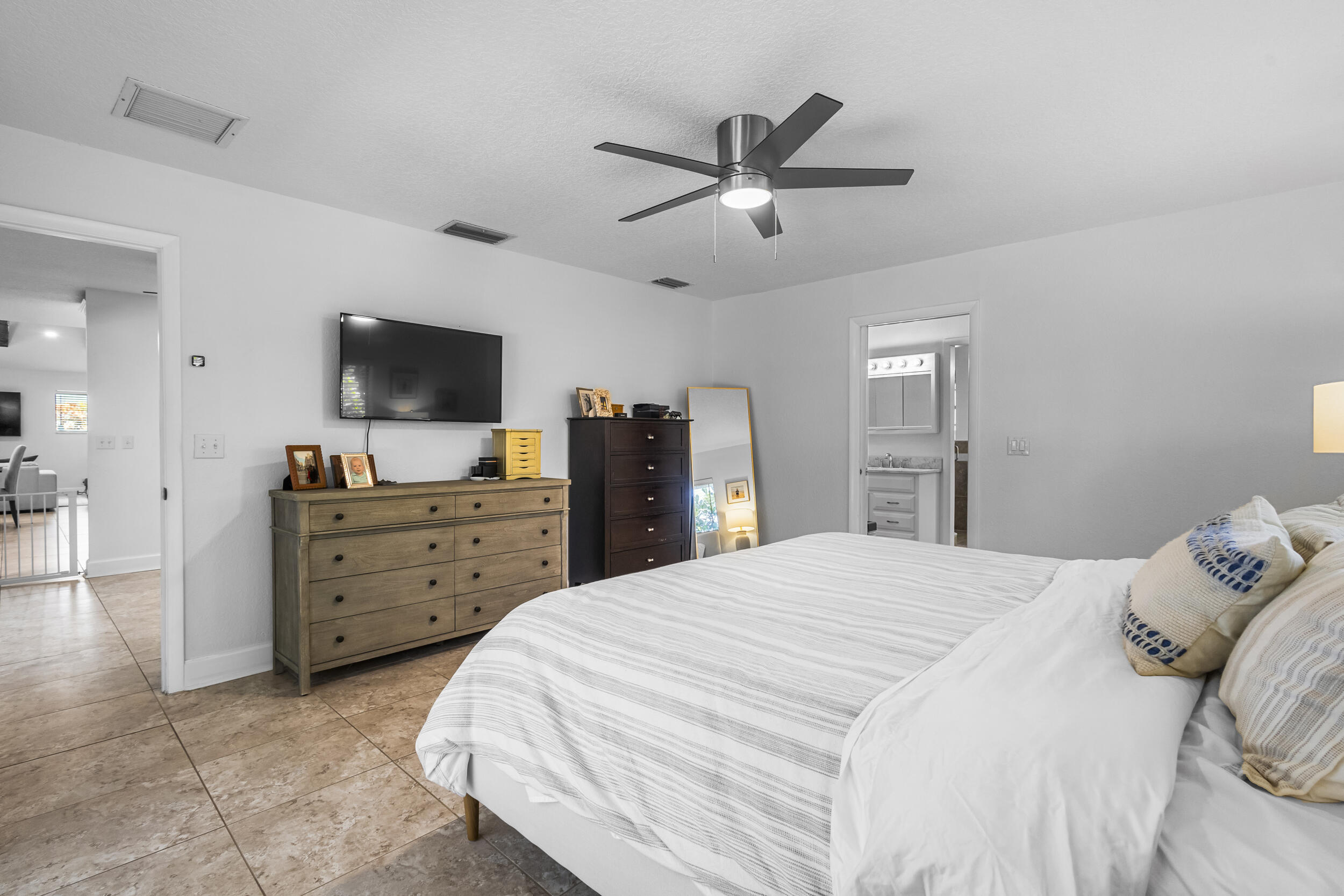 1948 Southwest 36th Avenue Delray Beach, FL 33445 - Photo 22 of 40 a bedroom with a bed and a flat screen tv