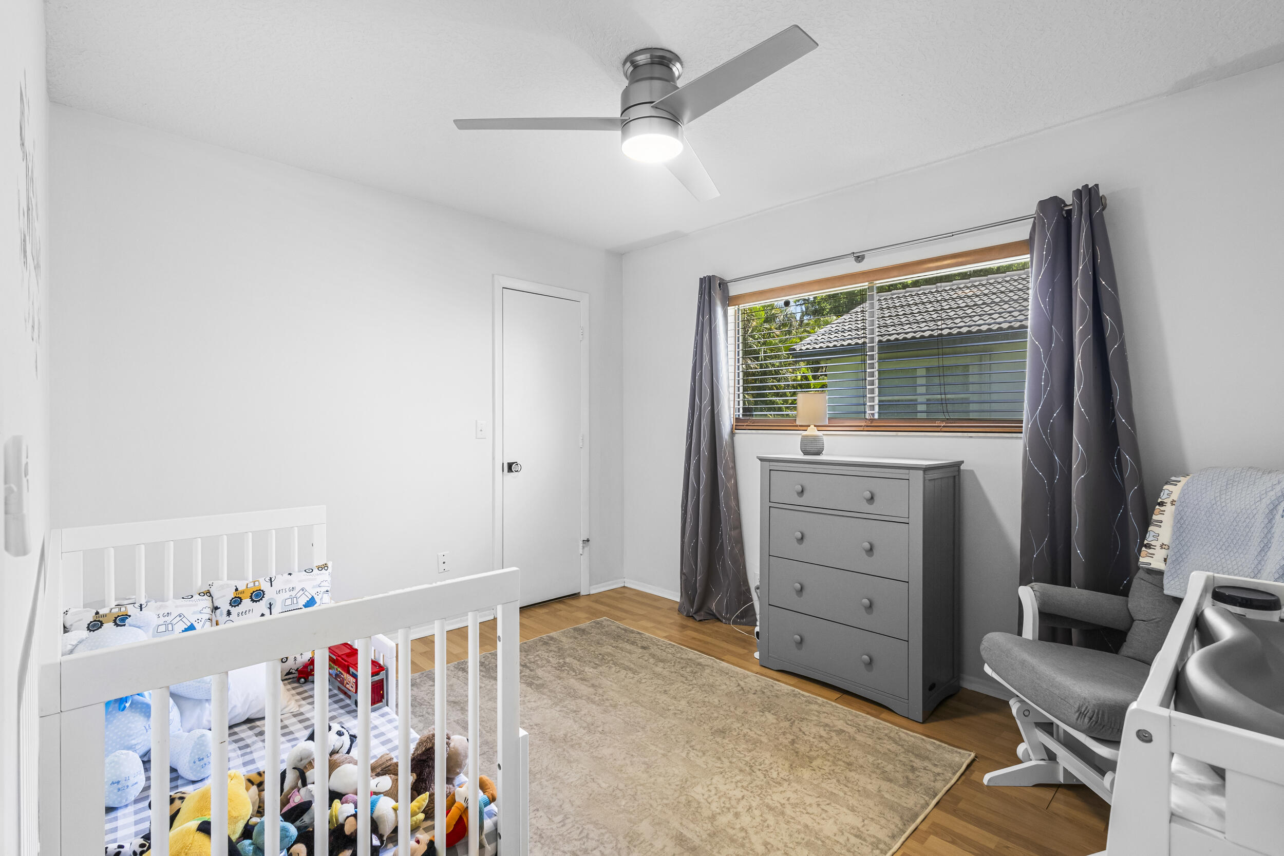 1948 Southwest 36th Avenue Delray Beach, FL 33445 - Photo 29 of 40 a bed room with a bed and a dresser