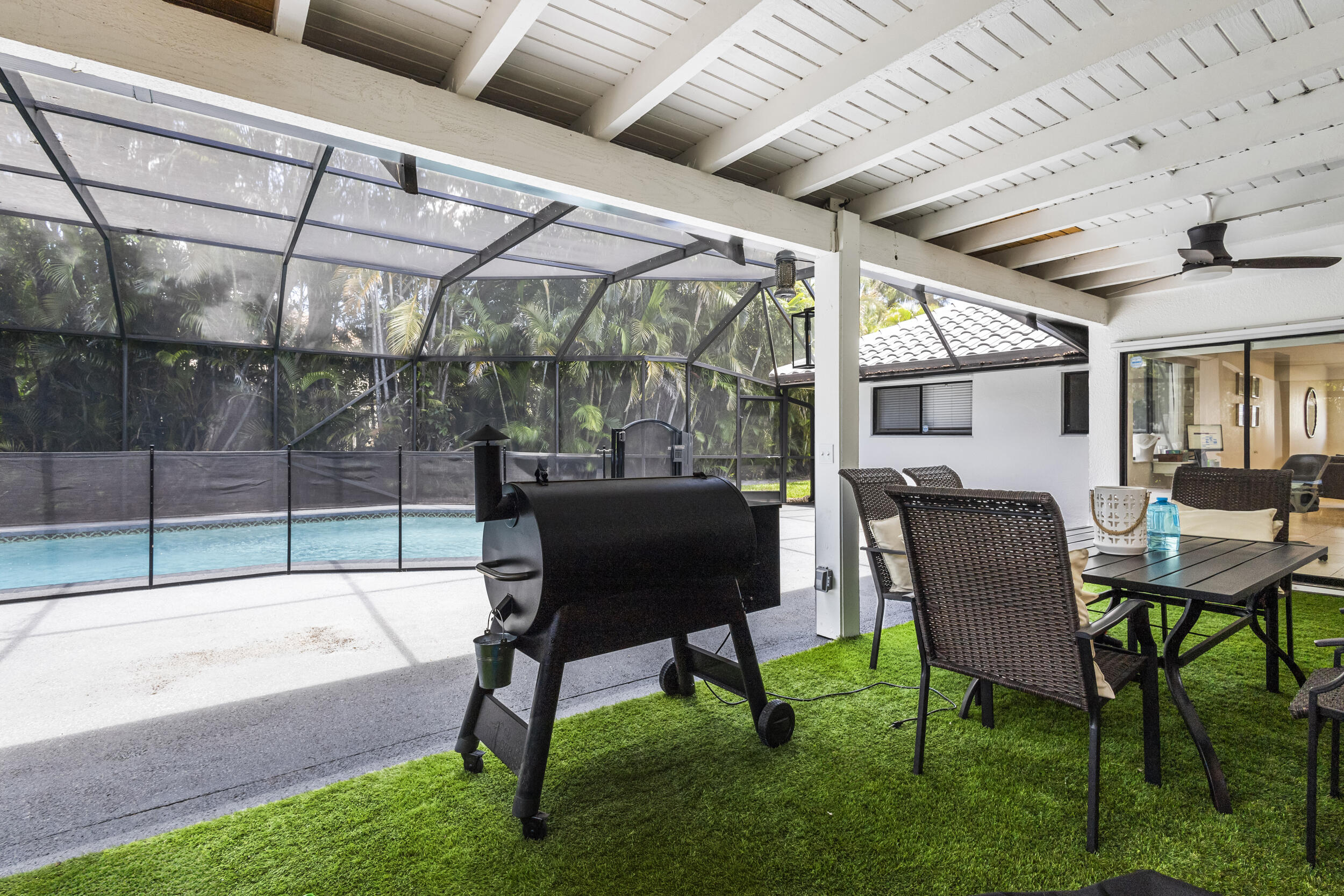 1948 Southwest 36th Avenue Delray Beach, FL 33445 - Photo 36 of 40 a view of a porch with furniture and a yard