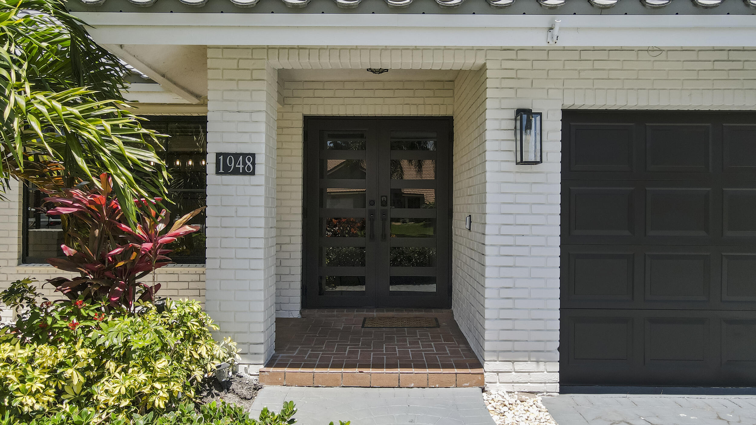 1948 Southwest 36th Avenue Delray Beach, FL 33445 - Photo 4 of 40 a front view of a house with a yard