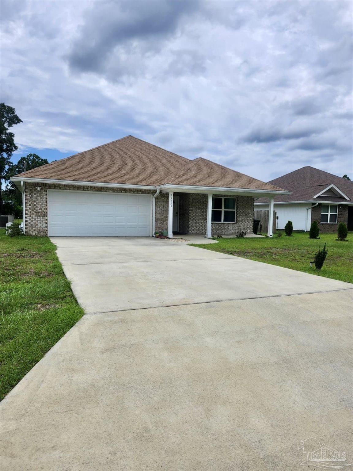 10425 Tanton Road Pensacola, FL 32506 - Photo 1 of 14 a front view of house with yard and green space