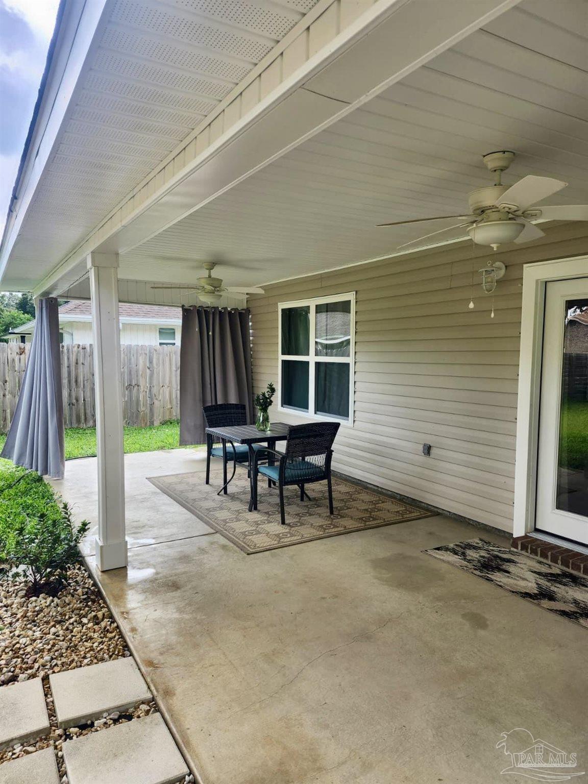 10425 Tanton Road Pensacola, FL 32506 - Photo 12 of 14 a view of a patio with table and chairs and potted plants