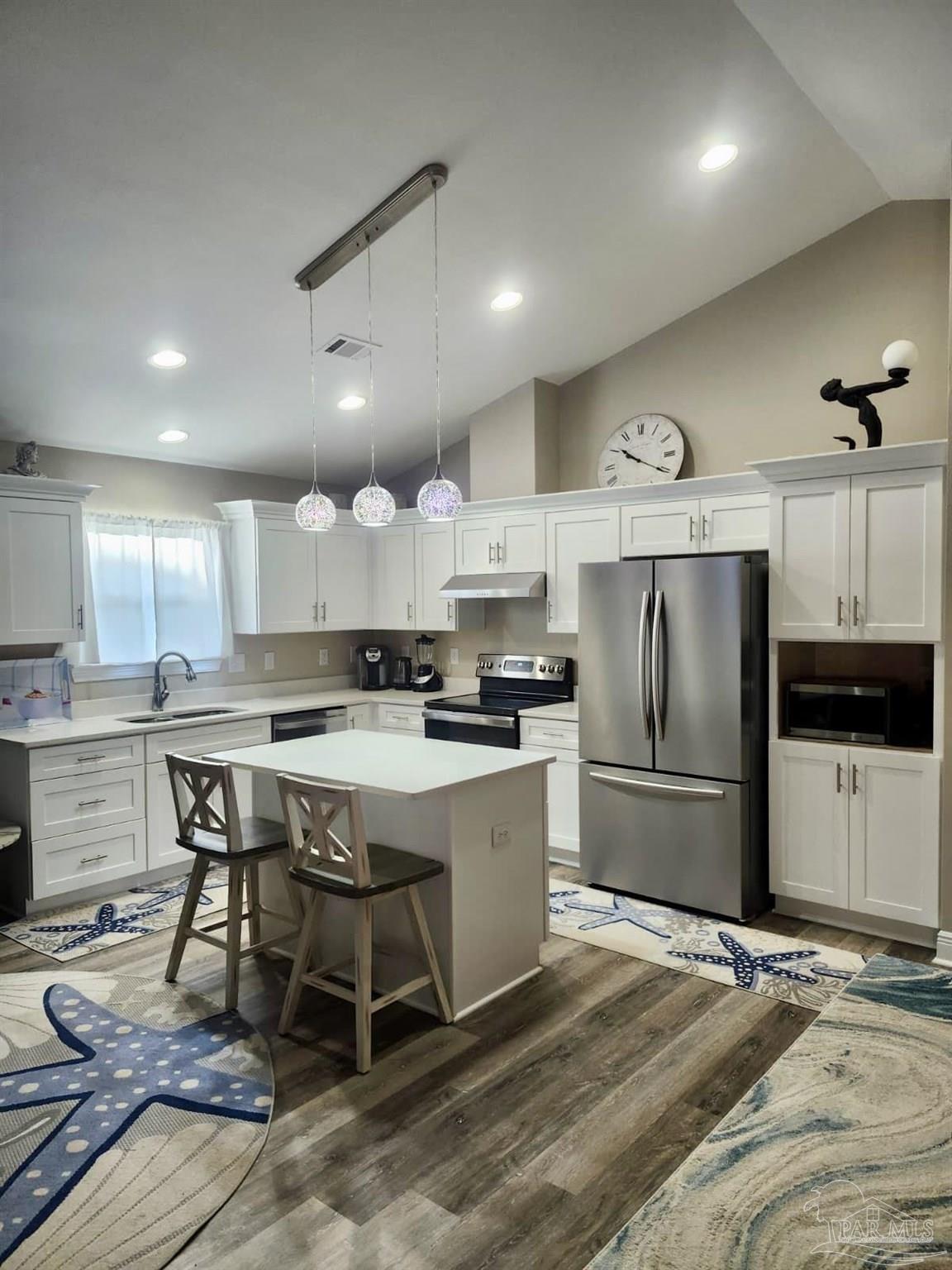 10425 Tanton Road Pensacola, FL 32506 - Photo 2 of 14 a kitchen with a refrigerator a stove a sink dishwasher with a dining table and chairs