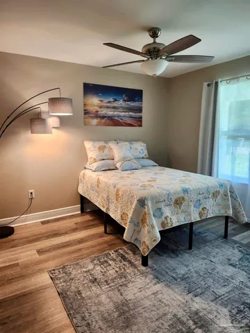 a bedroom with a bed table and window