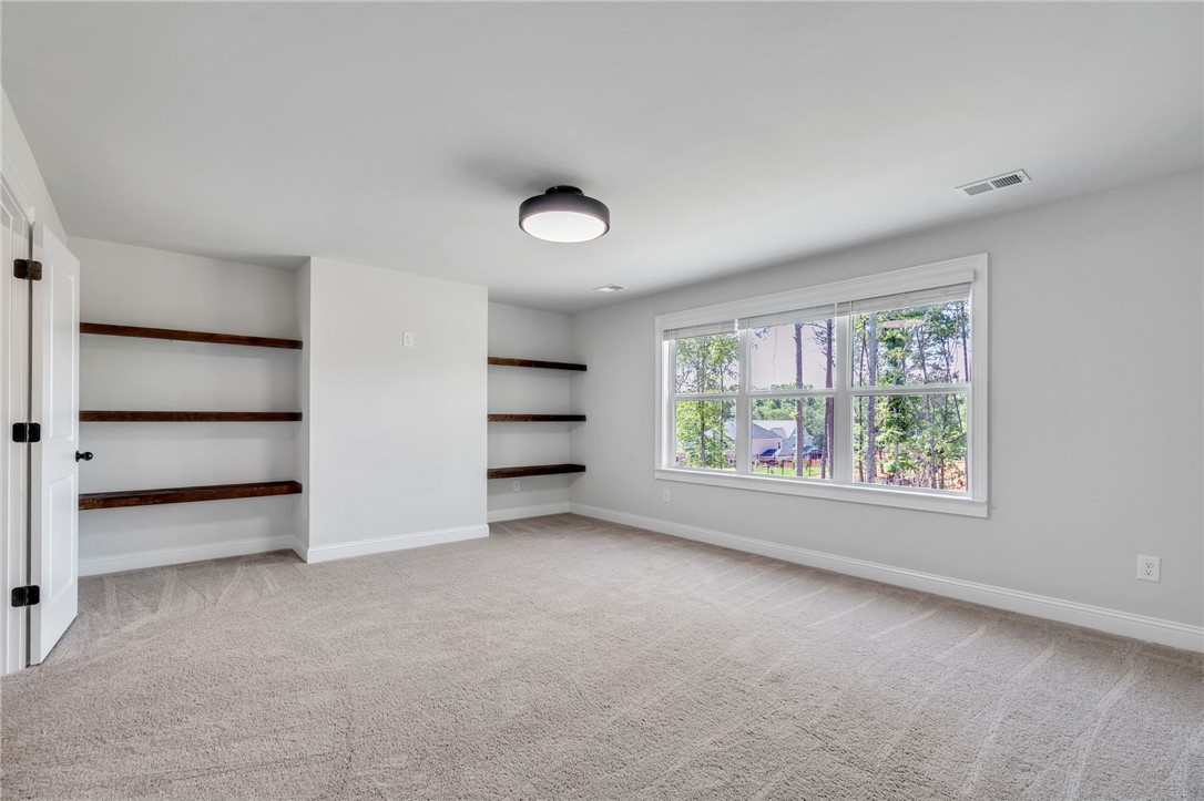 226 Holly Br Road Piedmont, SC 29673 - Photo 25 of 44 A spacious room offers ample natural illumination, with built-in shelving providing clever storage solutions.
