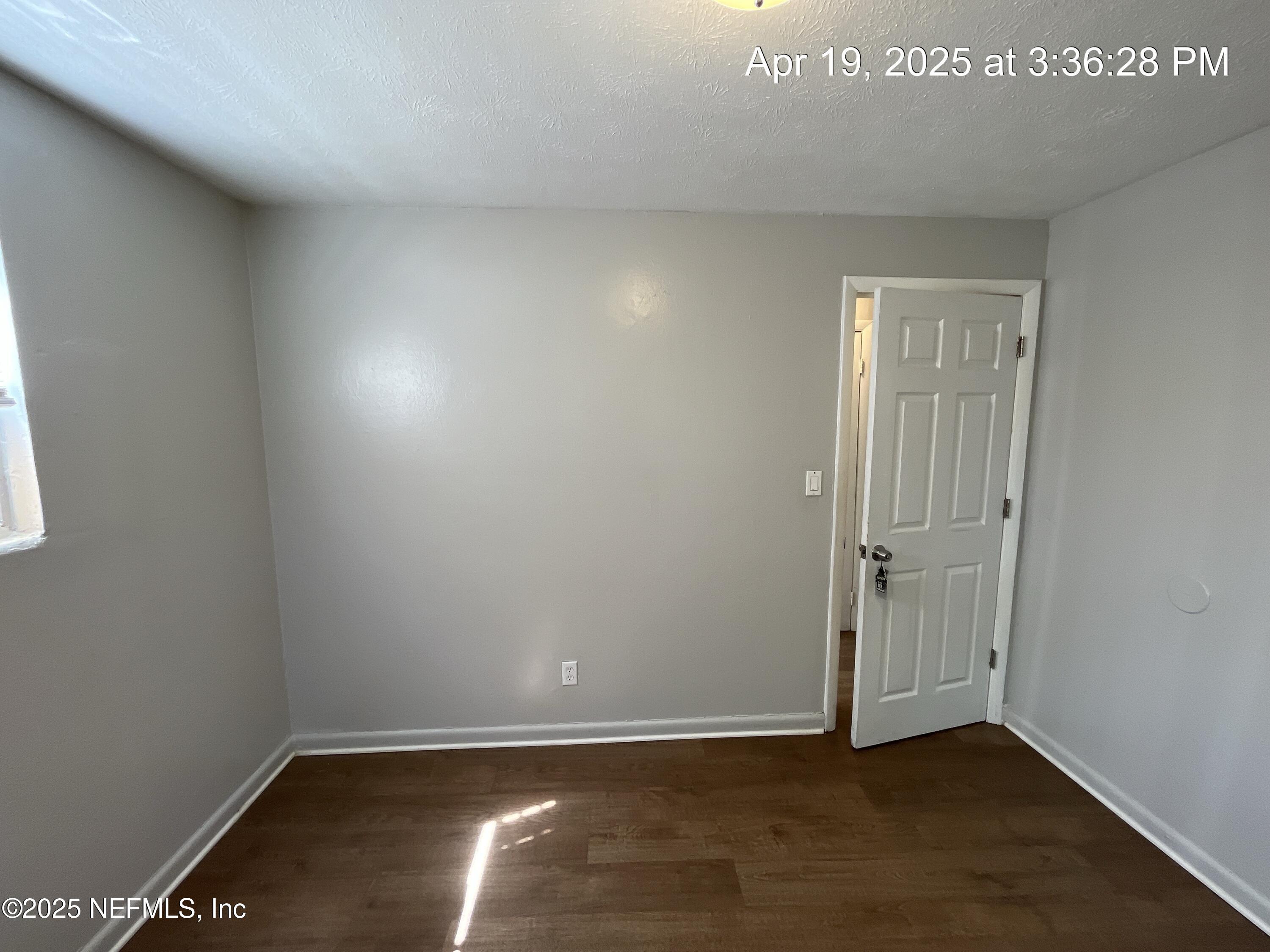 1616 West 36th Street Jacksonville, FL 32209 - Photo 4 of 7 an empty room with wooden floor and closet