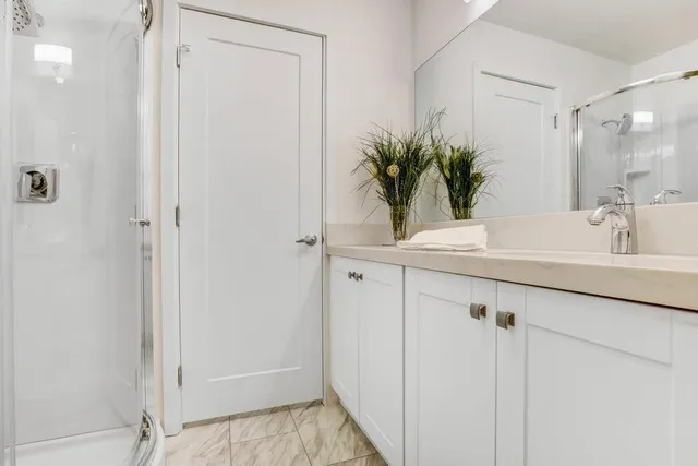 a bathroom with a shower curtain a mirror and a sink