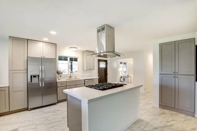 a kitchen with a refrigerator and a sink