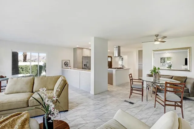 a living room with furniture and kitchen view