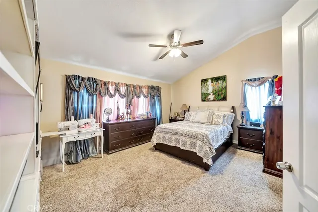 a bedroom with furniture and a flat screen tv