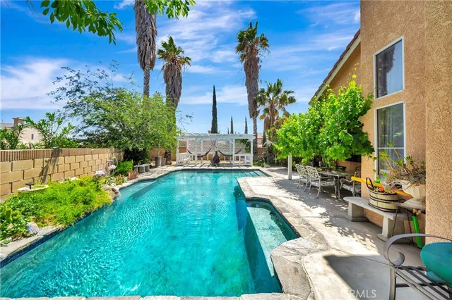 a front view of a house with a yard and potted plants