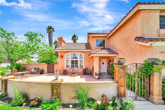 a living room with furniture a fireplace and a large window