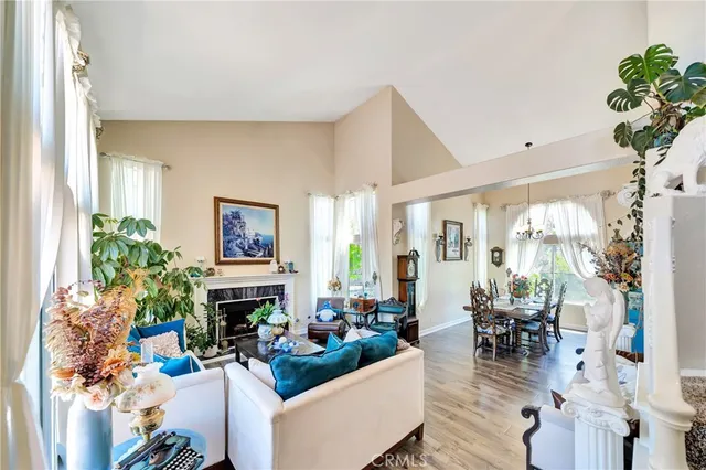 a view of a dining room with furniture a chandelier and a window