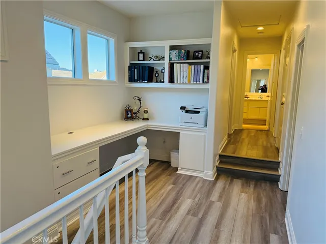 a bedroom with bed and wooden floor