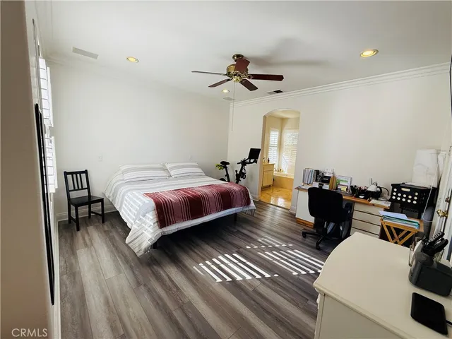 a bedroom with furniture and a flat screen tv