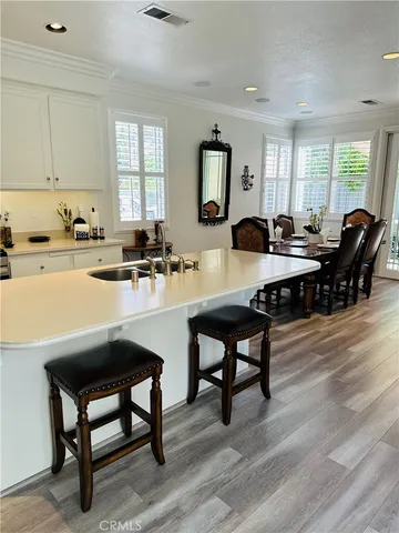a kitchen with a table chairs stove and cabinets