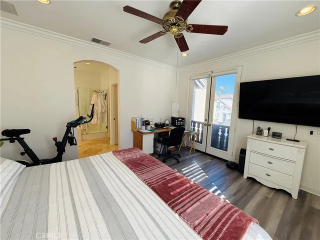 a bedroom with furniture and a flat screen tv