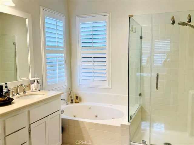 a bathroom with a tub sink and mirror