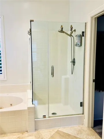 a bathroom with a bathtub and a shower