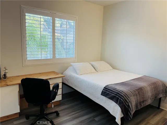 a bedroom with bed and window