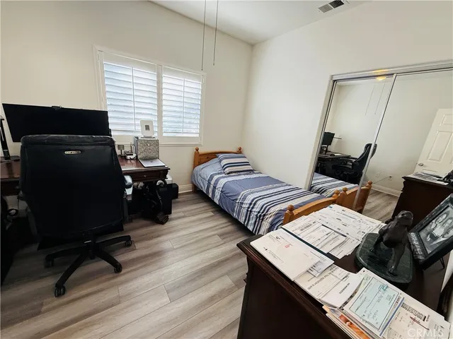 a bedroom with two beds and a desk