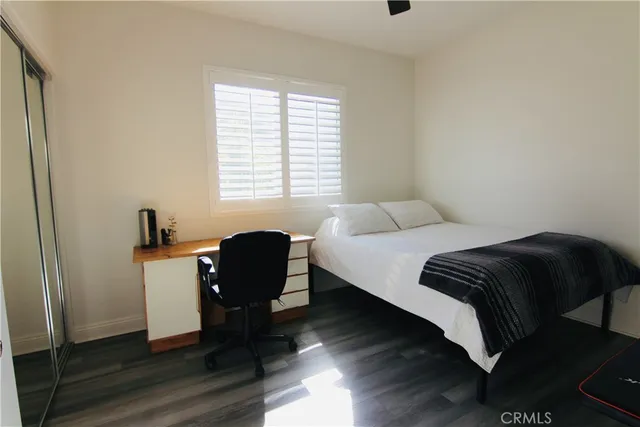 a bedroom with a bed and a chair