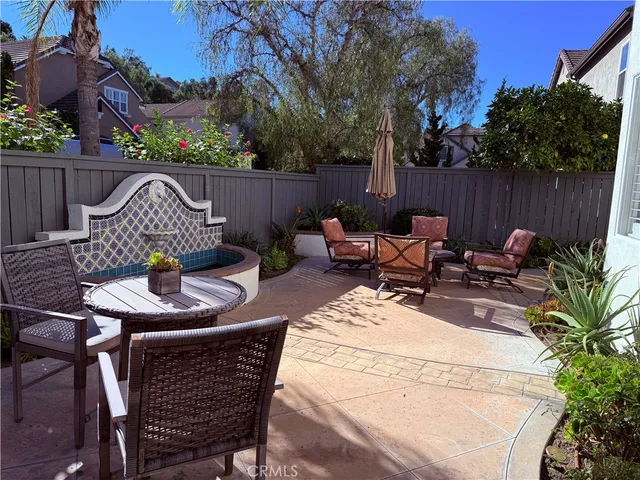 a view of a backyard with furniture and a grill