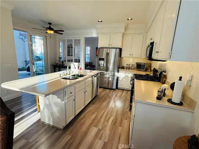 a view of kitchen dining table and chairs with wooden floor