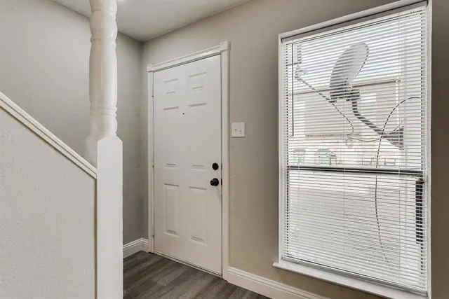 a view of front door with wooden floor