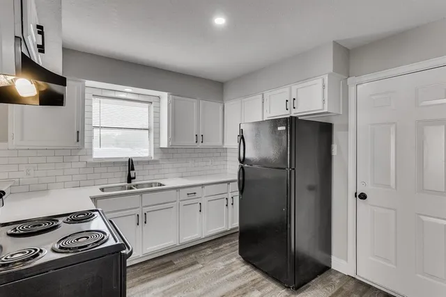 a kitchen with a sink stove and refrigerator