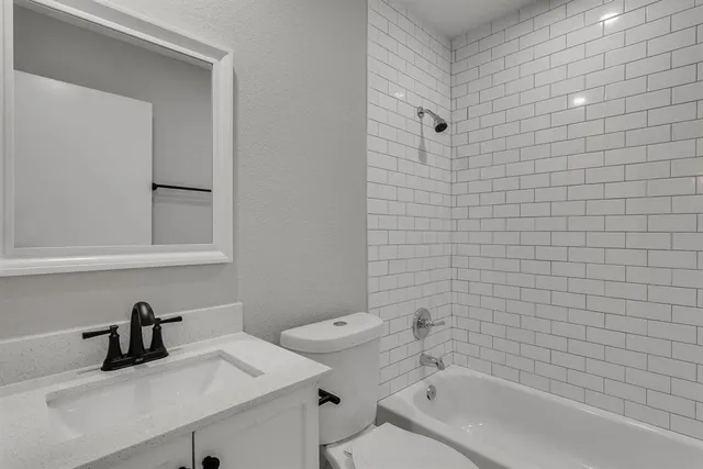 a bathroom with a sink a toilet and vanity